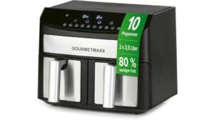 Schwarz-silberne Doppelkammer-Heißluftfritteuse mit Touch-Bedienung, Aufschrift „GOURMETmaxx“ und grünem Aufkleber mit deutschen Funktionen – ideal für alle, die Spitzenleistung suchen, wie in vielen Testberichten erwähnt wird.